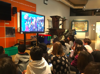 Children at Hackney Museum watching Voices Past and Present.